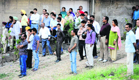 People gather to see the body of Sanaullah Khan, Pakistani prisoner, near the PGI mortuary in Chandigarh on Thursday.