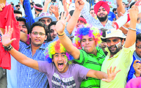 Fans cheer players during an IPL match between Kings XI Punjab and Rajasthan Royals at the PCA Stadium in Mohali on Thursday.