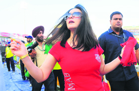 Preity Zinta throws T-shirts to cricket fans at the PCA Stadium in Mohali on Thursday.