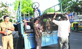 Muncipal Corporation staff remove a rehri during an anti-enchroachment drive at Sector 15 in Chandigarh on Thursday.