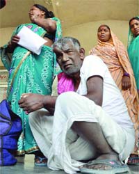 A patient waiting outside the OPD at Safdarjung Hospital where doctors went on strike in New Delhi on Thursday