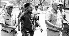 The police takes away Sandeep after he shot dead a relative in Bhiwani on Thursday