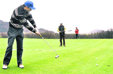 Golfers in action at the Royal Springs golf course in Srinagar. 