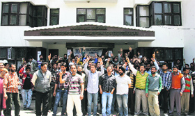 Daily wagers of Jammu and Kashmir Projects Construction Corporation block the main gate of their head office during a protest demanding reorganisation of their jobs.