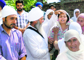 Grieving family members of slain Youth Congress leader Sukhraj Singh in Patti on Thursday.