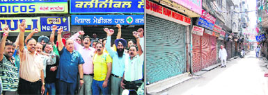 Activists of the Punjab Chemists Association stage a protest outside Guru Nanak Dev Hospital against the new National Pharmaceutical Pricing Policy of the Central Government; and (right) chemist shops at the medicine market, Katra Sher Singh, remain closed due to the strike by chemists in Amritsar on Friday.