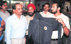 Parents show a synthetic tracksuit outside a shop in Sector 20, Chandigarh, on Friday.