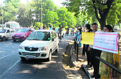 Guest teachers hold a protest at the Sector 16-17 roundabout in Chandigarh on Friday.