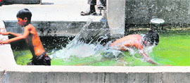 Children enjoy a dip in the central fountain at The Plaza,Sector 17, in Chandigarh on Friday. 