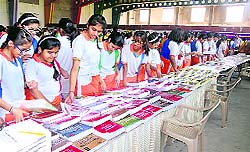 Students visit the book fair organised at Unison World School in Dehradun on Friday