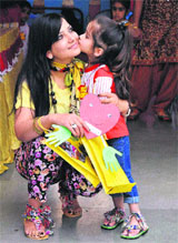 A girl kisses her mother in Shimla on Friday.