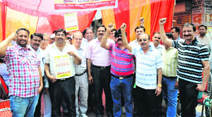 Chemists protest against the implementation of the Drug Price Control Act in Karnal on Friday. 