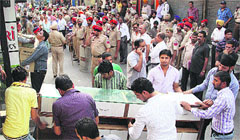 Traders vacate their shops following Supreme Court orders, in the Central Town area of Jalandhar on Friday. Photo: Sarabjit Singh