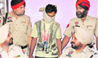 The murder accused in police custody in Jalandhar on Friday. A Tribune photograph