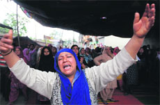 A relative of slain ASI Farooq Ahmed mourns during his funeral in Srinagar on Friday.