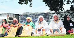 Members of Association of Parents of Disappeared Persons (APDP) hold photographs of their missing kin as they take part in a sit-in in Srinagar on Friday. Tribune photo: Amin War