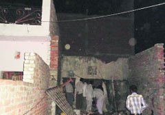 People gather at the site of the roof collapse in the Model Colony, Jagatpura Road, Ludhiana, on Friday. A Tribune photograph