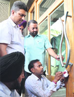 MC officials seal a portion of Hotel Majestic Park Plaza in Ludhiana on Friday. Photo: Inderjeet Verma