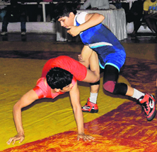 Women wrestlers in action during the wrestling championship at the Skating Rink in Sector 10, Chandigarh, on Saturday.