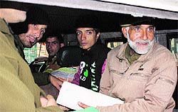 Danish Farooq Wani (second from right) being taken to a police station from a local court in Srinagar