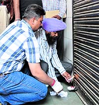 MC officials seal the workshop of Khushi Ram and Sons in Ludhiana on Saturday