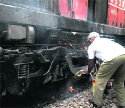 A fireman douses flames aboard an engine of Garib Rath Express in Gurgaon on Monday.