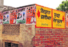 Posters of SAD and Congress candidates pasted on a wall in Gidderbaha. 