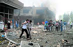 People help injured at an explosion site in Reyhanli, near Turkeys border with Syria, on Saturday