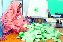 An official empties a ballot box at the end of polling in Rawalpindi