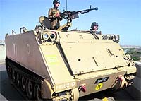 Soldiers patrol on an armoured personnel carrier in Karachi