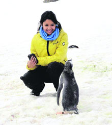 Sonal Asgotraa with a penguin in Antarctica.