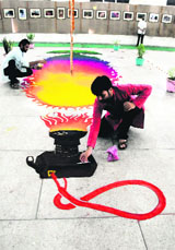 An artist gives finishing touches to a rangoli on the concluding day of the 14th Rahul Kaushal Yadgaari Mela at Teachers Home in Bathinda on Sunday.