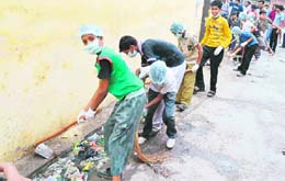 Schoolchildren clean a drain as part of a cleanliness campaign in Haridwar on Sunday