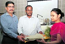 SSP Kewal Khurana and District Magistrate BVRC Purushottam honours Ritika Bhandari at a function held at the Police Lines in Dehradun on Sunday