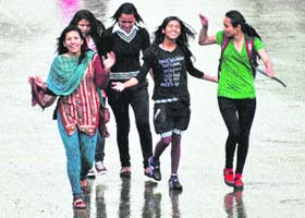 Girls enjoy in the rain in Shimla on Sunday