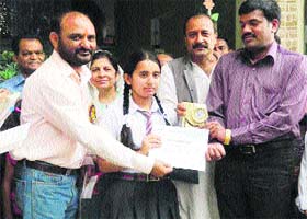 Kangra Deputy Commissioner C Pal Rasu (extreme right) awards winner of an inter-school quiz and declamation contest at Nurpur on Saturday