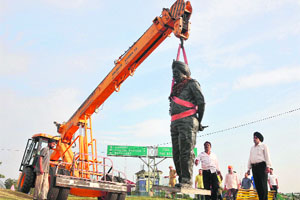 The statue of Lt Gen Bikram Singh, PVSM, being shifted from Bikram Chowk to Tawi Bridge in Jammu on Sunday. 