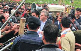 Chief Minister Omar Abdullah shakes hands with people during a rally at Pattan in Baramulla district on Sunday. 