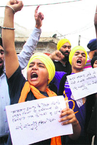 Activists of the Jammu and Kashmir Sikh Council protest against the UPA government over Congress leader Sajjan Kumars acquittal in the 1984 anti-Sikh riots, in Jammu on Sunday. 