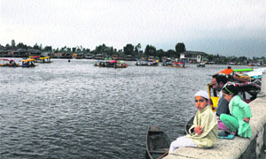 A family on the banks of the Dal Lake in Srinagar on Sunday. 