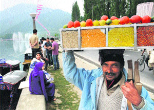 A roadside vendor sells bhel puri near the Dal Lake in Srinagar on Sunday. 