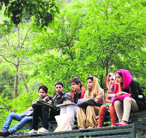 Youngsters watch a musical programme in Srinagar on Sunday. 