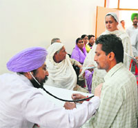 A doctor checks a patient during a medical check-up camp at Ludhiana.