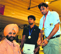 Coach Ashok Dhaka (in blue) accepted the gold medal on behalf of his trainee Amit, who had won in the 74 kg Greco-Roman category. 