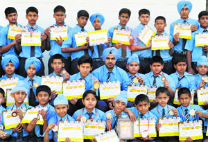 Students of Golden Bells Public School show their medals and certificates after winning the overall trophy in the All-India Open Table Soccer Championship-2013. 