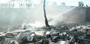 Firemen douse the flames at a store at Phabhat village, Zirakpur, on Monday. 
