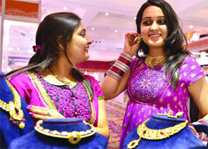 Women at a jewellery shop on the glittering occasion of Akshaya Tritiya in New Delhi on Monday.