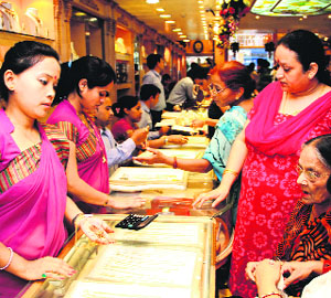 People buy gold ornaments on the occasion of Akshay Tritiya in Dehradun on Monday. 