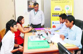 Two girls appear for an interview while Principal Gurcharan Dass (standing) looks on in a job fair in the JCDM College of Engineering in Sirsa