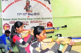 Girls participate in the Kurukshetra District Shooting Championship at the Naveen Jindal Shooting Range in Kurukshetra